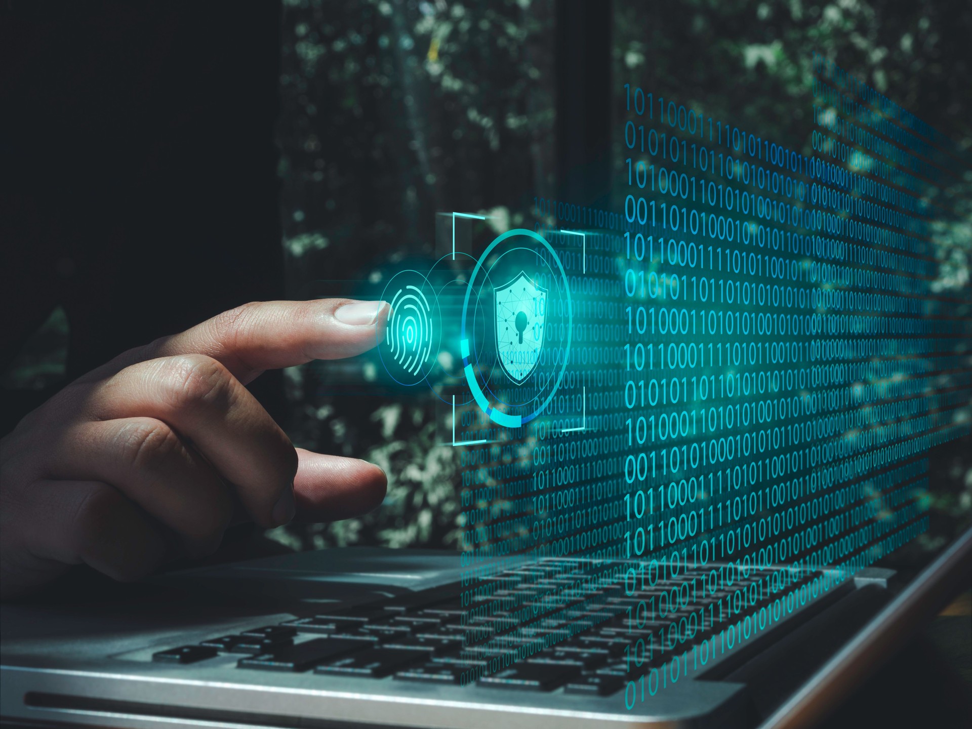 Security data technology, identity verification, and personal privacy concept. Shield icon, fingerprint scan symbol on random numbers code virtual screen with man pointing finger and laptop computer.